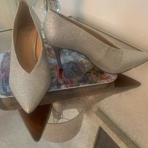 Never worn silver pumps.